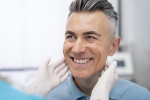 Patient smiling after getting same-day crowns at Mann Family Dental Care