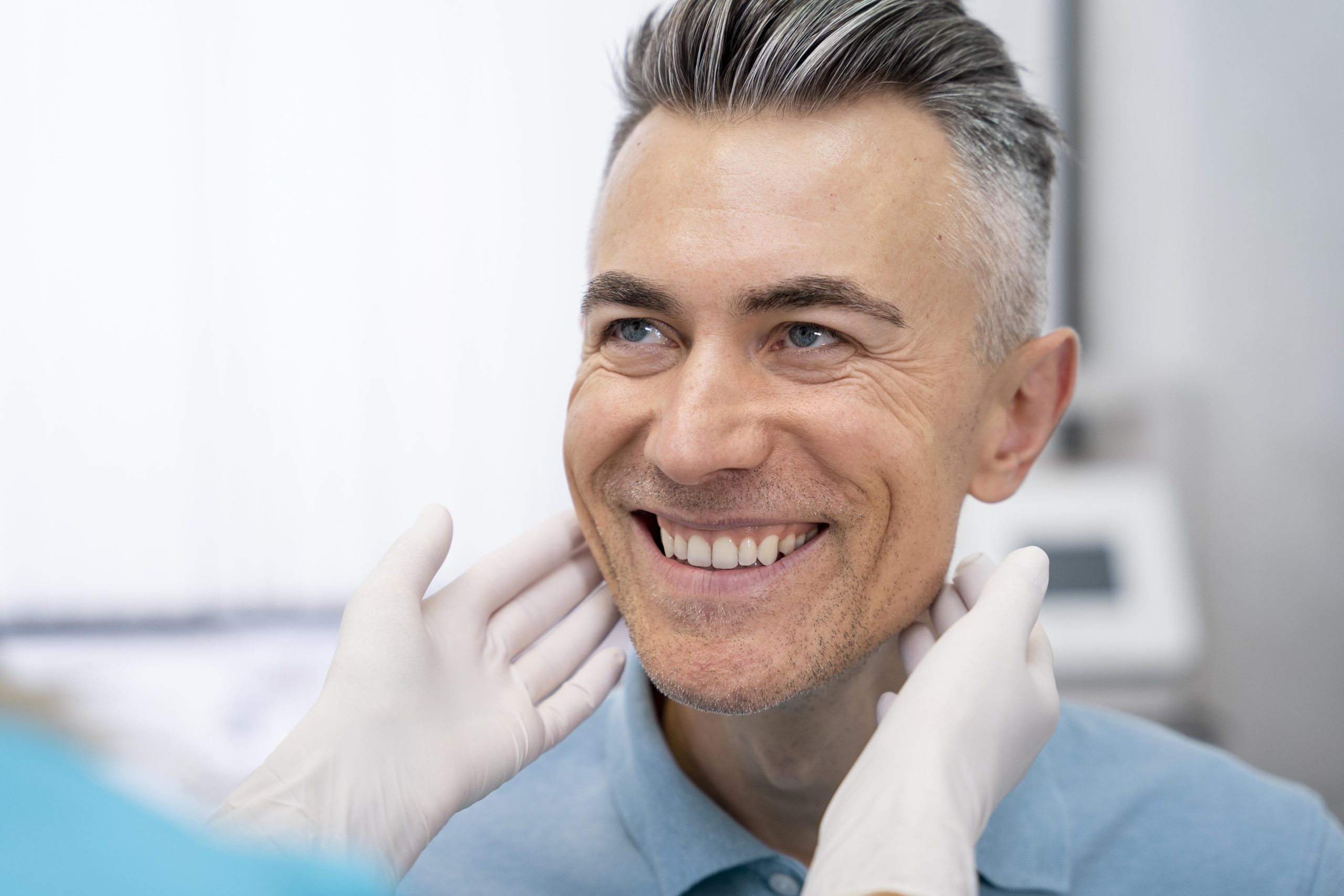 Patient smiling after getting same-day crowns at Mann Family Dental Care
